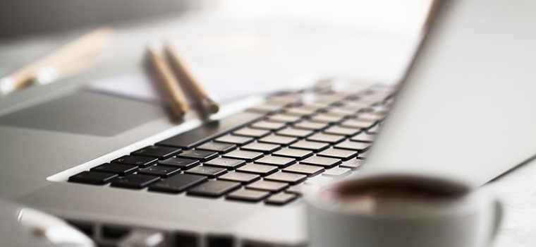 Closeup of Workspace with Modern Creative Laptop, Cup of Coffee